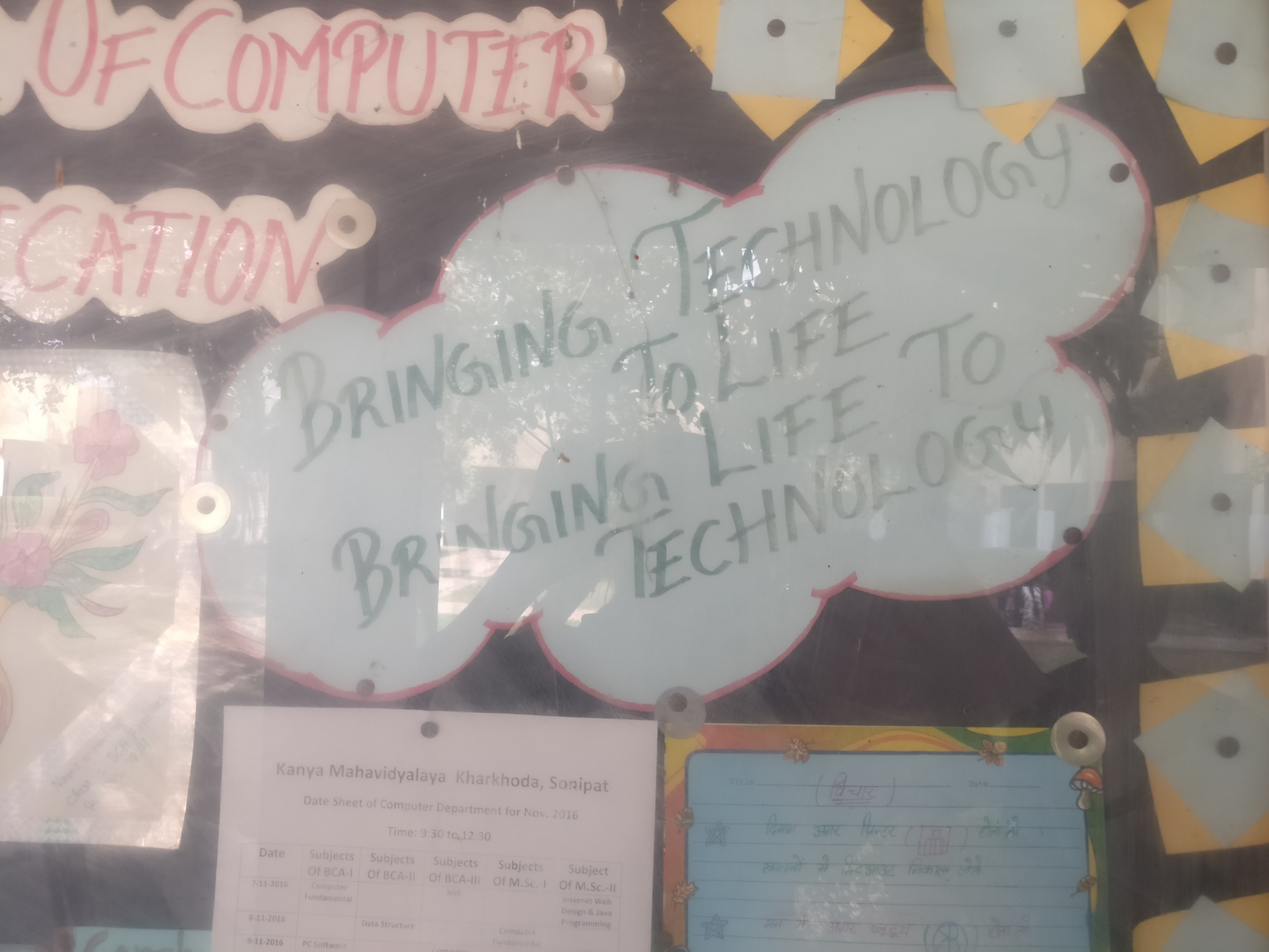 A sign on technology and life on a board in a college